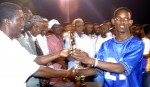 A player from a previous tournament receiving the MVP trophy