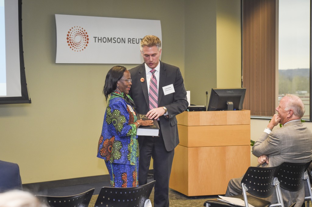 Ambassador Liberata Mulamula receives a law manual from Tom Pfeifer of Thomson Reuters after she spoke about trade opportunities in her country on May 7 2014 at Thomson Reuters headquarters organized by the Minnesota Trade office. Thomson Reuters is a leading publisher of law books. Photo: Courtesy Thomson Reuters
