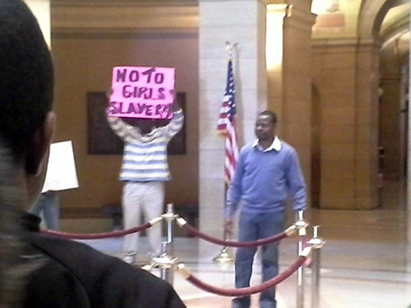 A protester at a May 10, 2014 rally at the State Capitol in St. Paul, Minnesota carries  a sign condemning the enslavement of Nigerian girls abducted by Boko Haram. Photo: Senah Yeboah-Sampong/Mshale