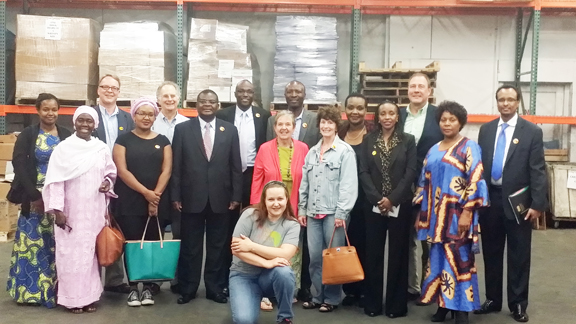 Ambassador Robinson Njeru Githae of Kenya (6th from left) at the Books for Africa Saint Paul, Minnesota warehouse after witnessing the donation of over 22,000 textbooks in memory of Ishmael Gitaa, father to Mshale founder and publisher, Tom Gitaa on Thursday, June 4, 2015. The donation was given jointly by Books for Africa and MKIDA. Books for Africa is the largest shipper of donated textbooks to Africa. Photo: Courtesy of BFA 