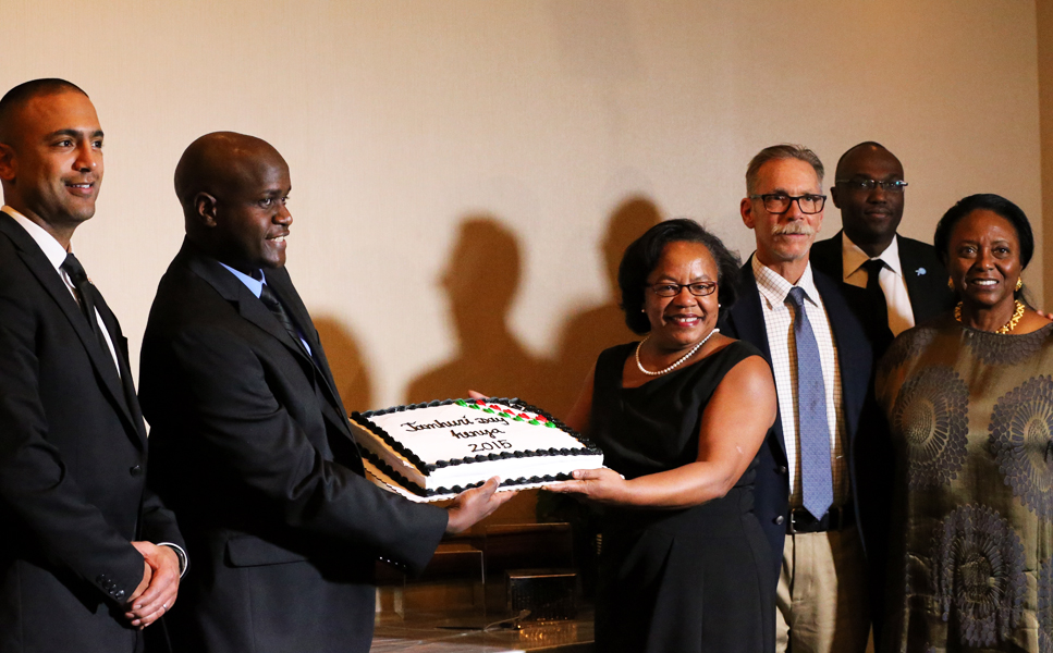 The chairman of the 2015 Jamhuri Day Committee in Minnesota, Geoffrey Gichana and former Minneapolis mayor Sharon Sayles Belton hold the cake marking the occasion of Kenya's 52nd Jamhuri Day on Saturday, December 12. The mayor, the first female mayor of Minnesota's largest city and commercial center, keynoted the independence dinner at a local hotel. The two are flanked by others who spoke at the dinner, Salim Omari, Dr. Karl Anderson and Judge (ret.) Lajune Lange. Photo: Courtesy of KDR TV