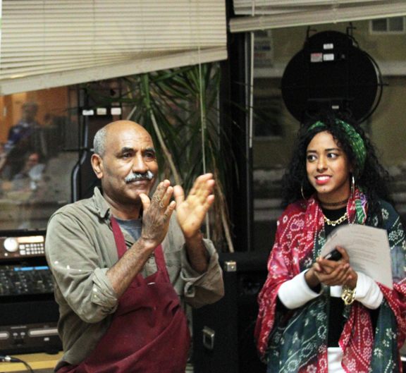 Snelling Cafe owner Afeworki Bein, cheers a performer as curator Lula Saleh looks on during Little Africa's first open mic and dialogue series held at the cafe on January 20, 2016. Photo; Courtesy AEDS