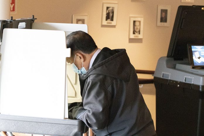 Man Voting in Brooklyn Park City Hall on Saturday April 10 2021