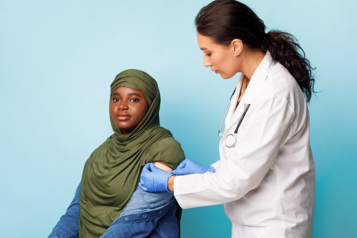 Coronavirus,Vaccination,Campaign.,African,Muslim,Female,Patient,In,Hijab,Getting
