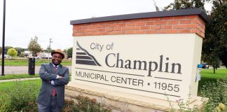 Samuel Mwangi keeps making his case to Champlin voters Samuel Mwangi, a Champlin City Council Ward 4 candidate, stands beside the Champlin Municipal Center sign in Champlin, Minnesota.