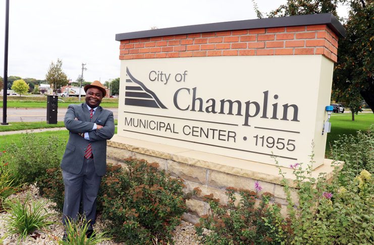 Samuel Mwangi keeps making his case to Champlin voters Samuel Mwangi, a Champlin City Council Ward 4 candidate, stands beside the Champlin Municipal Center sign in Champlin, Minnesota.