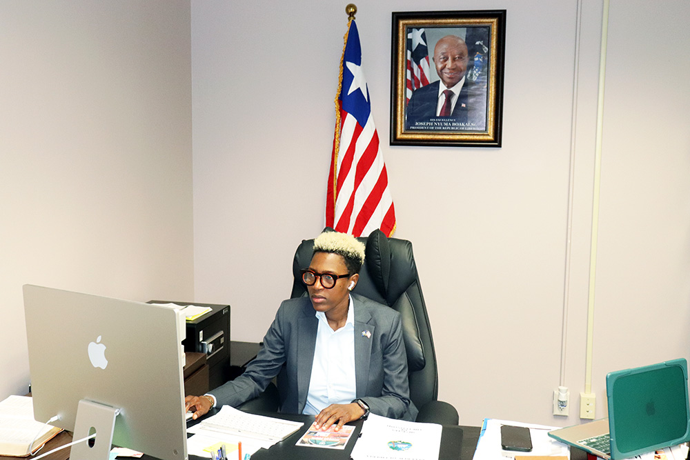 Liberian Consul General Tracy Ashley Grigsby seated at her desk in the Brooklyn Park consulate