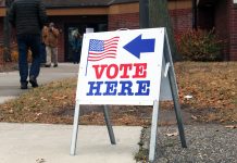 Twin Cities groups launch ‘Power of Five’ voter mobilization ahead of November election Vote Here sign outside a Minneapolis polling location as people walk toward the building during a previous election