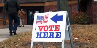 Twin Cities groups launch ‘Power of Five’ voter mobilization ahead of November election Vote Here sign outside a Minneapolis polling location as people walk toward the building during a previous election