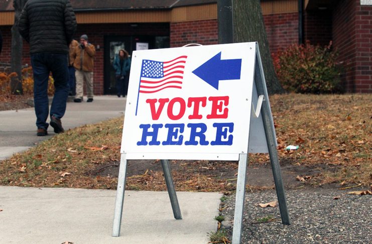Twin Cities groups launch ‘Power of Five’ voter mobilization ahead of November election Vote Here sign outside a Minneapolis polling location as people walk toward the building during a previous election